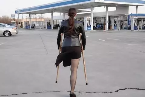 AI Video from prompt: A beautiful one-legged woman turns her back to t