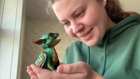 AI Video from prompt: I am holding baby dragon in my hands and video c