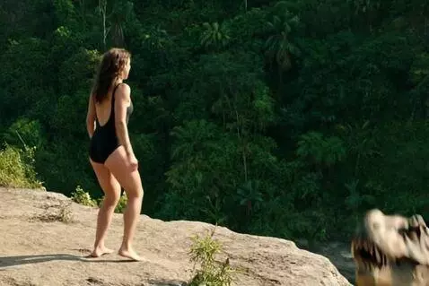 AI Video from prompt: “A woman in a black swimsuit stands at the cliff