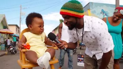 AI Video from prompt: A funny Jamaican street interview scene. A baby 