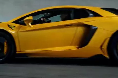 AI Video from prompt: A bright yellow Lamborghini Aventador SVJ speeds