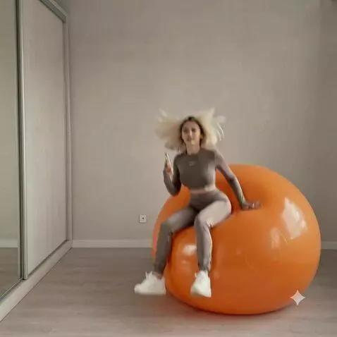 AI Video from prompt: The girl sits on this orange fitball and the gir