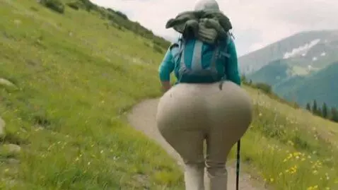 AI Video from prompt: a woman on a hike. suddenly her hips and rear be