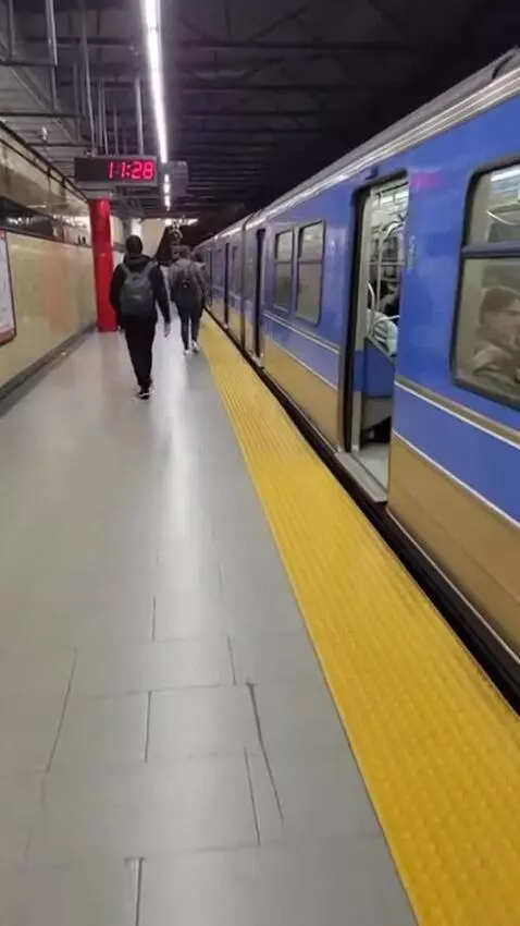 AI Video from prompt: Walking along the platform of a subway station i