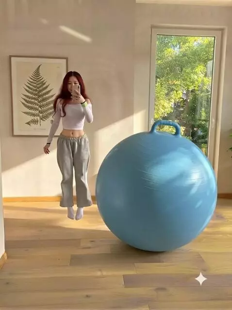 AI Video from prompt: The girl sits on a blue fitball and the girl hol