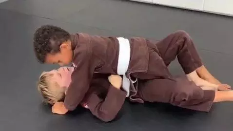 AI Video from prompt: two boys at six years,wearing brown bjj jackets,