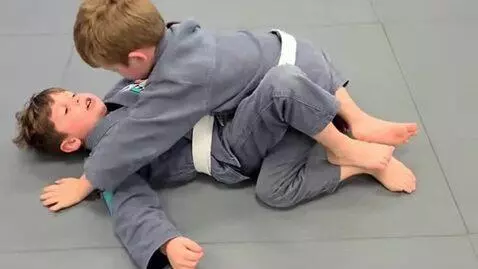 AI Video from prompt: two boys at six years,wearing gray bjj jackets,w
