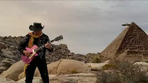 AI Video from prompt: the guitarist plays a fast solo , plasma arcs up