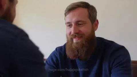 Close-up of a man with a beard, wearing a blue sweater, asking 'Philip, where is my beer?'
