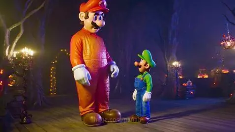 Giant Mario and smaller Luigi stand in a Halloween-themed environment with pumpkins and spooky trees.