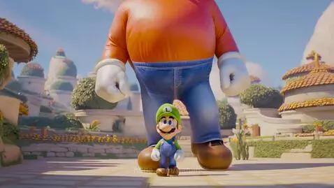 Giant Mario in red cap and orange shirt bends down to hug a smaller Luigi in green shirt and overalls.