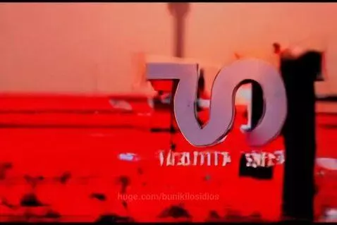 Abstract digital art with glitch effects, featuring red and orange colors and a large metallic number '75'.