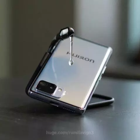 Close-up of a silver smartphone with a 'HUIZON' logo, as clear liquid drips onto its back from a black object.