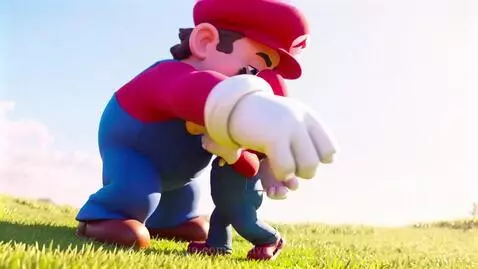 Giant Mario character affectionately hugging a smaller Luigi character in a grassy field under a blue sky.