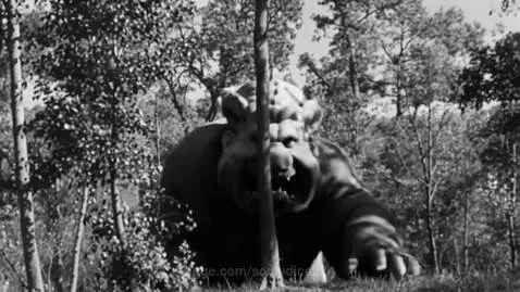 A grotesque, troll-like Giant Mario with sharp teeth and clawed hands moves menacingly through a dark forest.