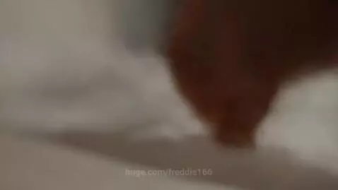 Woman at a desk with a laptop and electronic device, holding an apple and stylus.