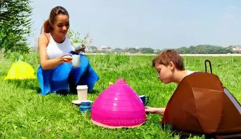 Two rats, one black named Diana and one white named Katya, drinking coffee during an outdoor picnic on a sunny day.