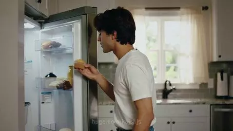 Young man eating a cupcake in a kitchen is hit in the head by a flying chancla, with a comic book graphic.