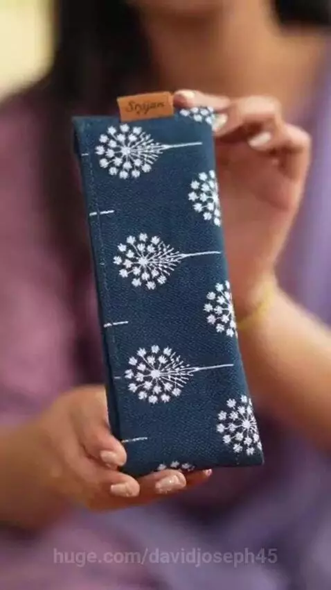 South Asian influencer showcases handcrafted indigo fabric glasses case with white dandelion print.