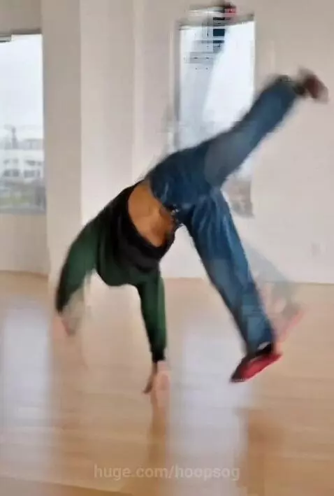 Young woman in gymnastics leotard performing a tumbling pass with digital lightning effects.
