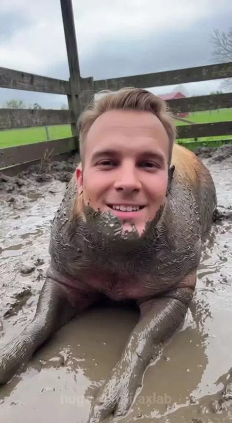 Man with pig's head in a muddy pen, then in a car, smiling.