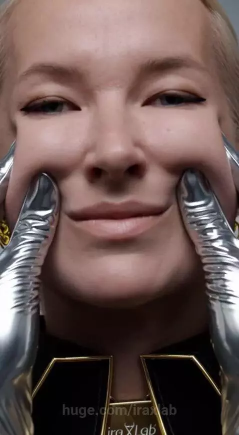 Blonde woman's face being manipulated by hands in shiny silver gloves, causing facial contortions.