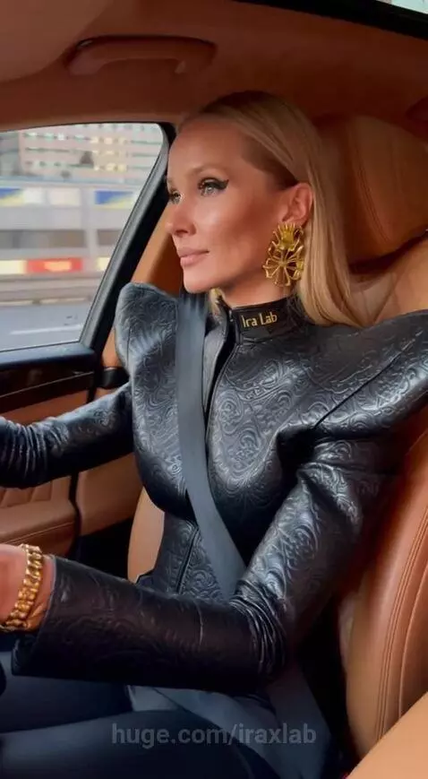 Woman driving a luxury car with a CGI hyena wearing a seatbelt and laughing in the backseat.