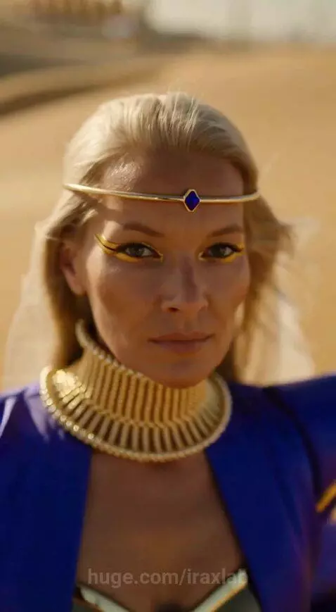 Woman in a blue and gold ancient-futuristic costume with a flowing cape walks through a desert.