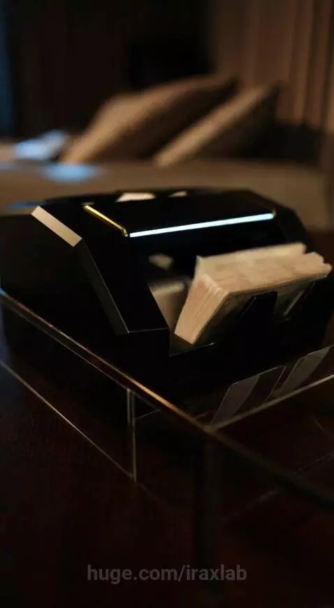 Close-up of a woman resting with a money counting machine processing cash bills in the background.