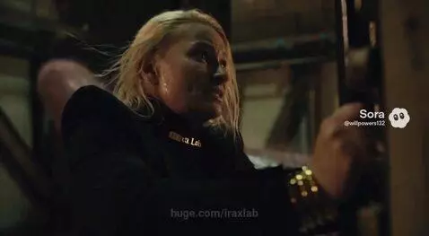 Woman running from a large worm-like creature into a metal door, then ascending a glowing shaft.