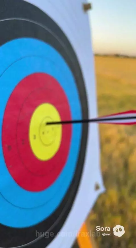 Woman practicing archery at sunset, arrow flying towards target.