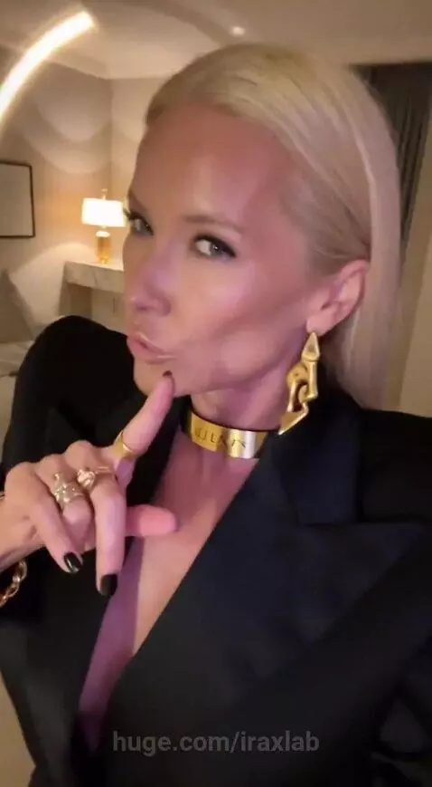 Woman in a black blazer and gold jewelry discussing her daily dilemma about diet and weight loss.