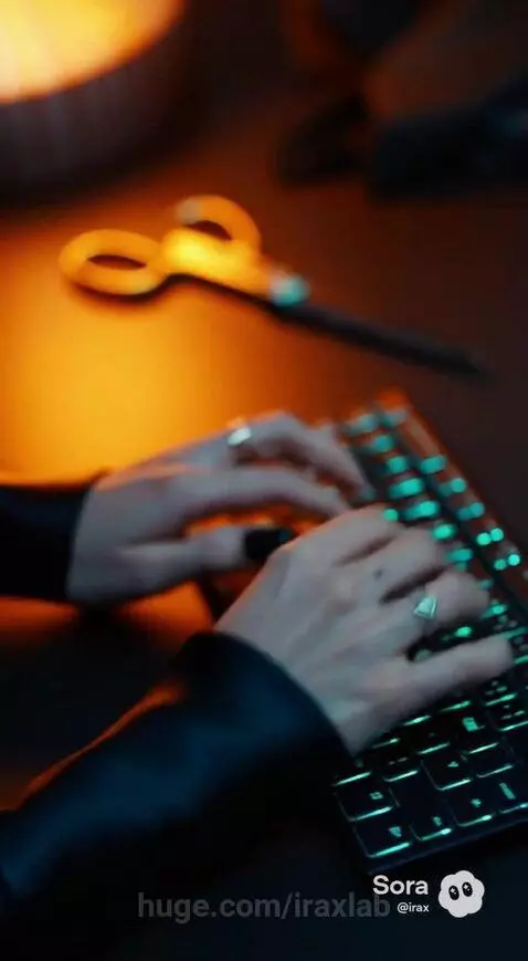 Woman in futuristic outfit designs fashion on a laptop with city lights at night.