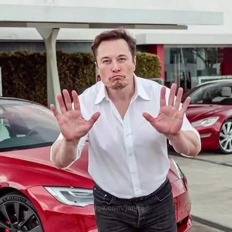 Elon Musk unbuttons his shirt and dances enthusiastically in front of a Tesla car.