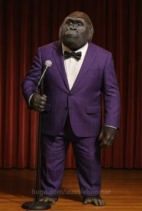A gorilla in a purple plaid suit and bow tie stands on a stage holding a microphone, ready to tell a joke.
