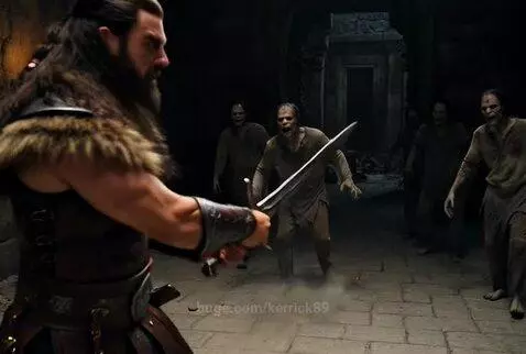 Muscular warrior with sword fighting zombies to protect a blonde princess in a dark stone chamber.