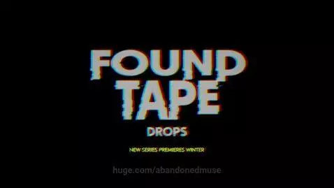 Glitchy found footage of an empty, yellow-lit corridor with a shadowy figure at the end.