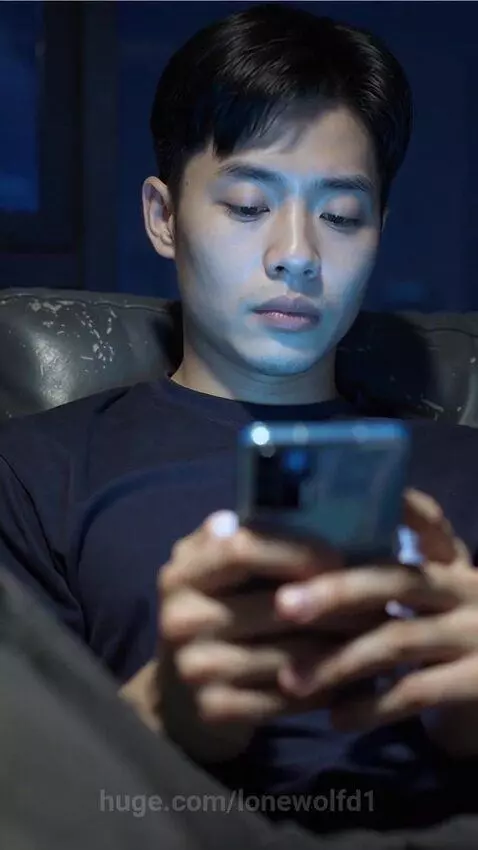 Young man engrossed in smartphone, screen transitions to cosmic light and a V logo.