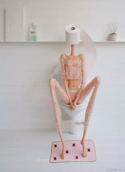 Surreal doll with toilet paper head and embellished clothing on a balcony with the Eiffel Tower.