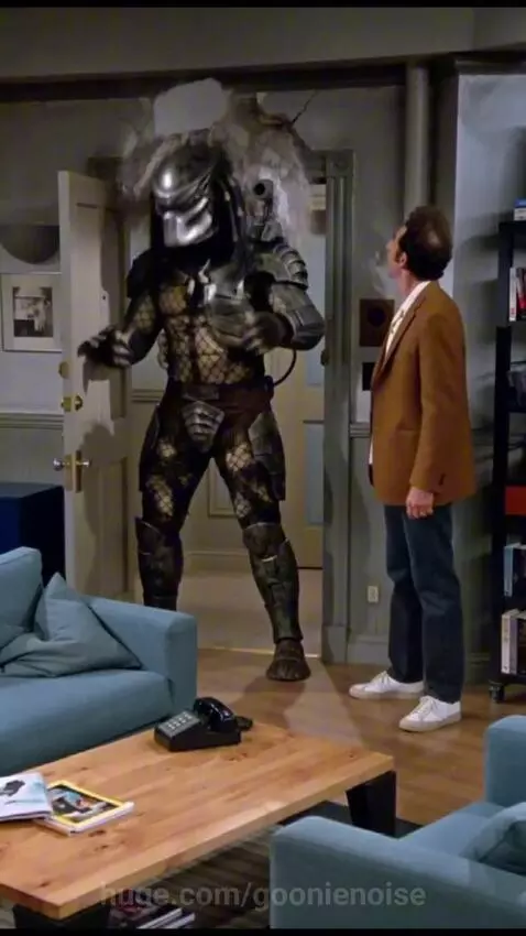 Kramer introduces the Predator to Jerry in a Seinfeld apartment scene, with plaster falling from the doorway.