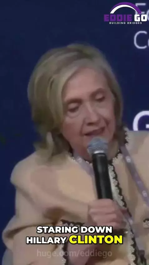 Czech Deputy PM Petr Musinka confronting Hillary Clinton on stage with animated graphics.