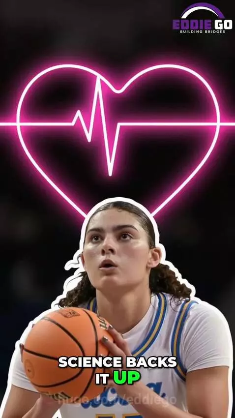 Basketball player shooting a free throw with a loud, costumed crowd in the background.