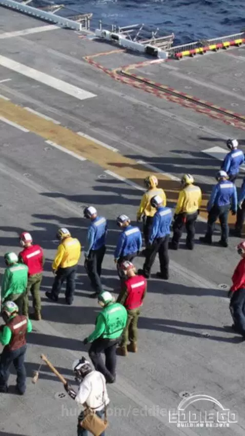 Fighter jet launching from an aircraft carrier deck with speed lines indicating rapid acceleration.