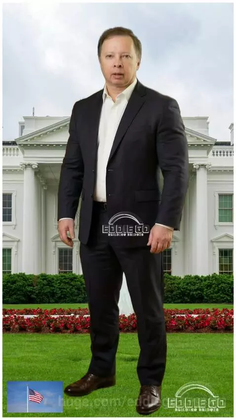 Man in suit speaking on White House-like lawn with American flag.