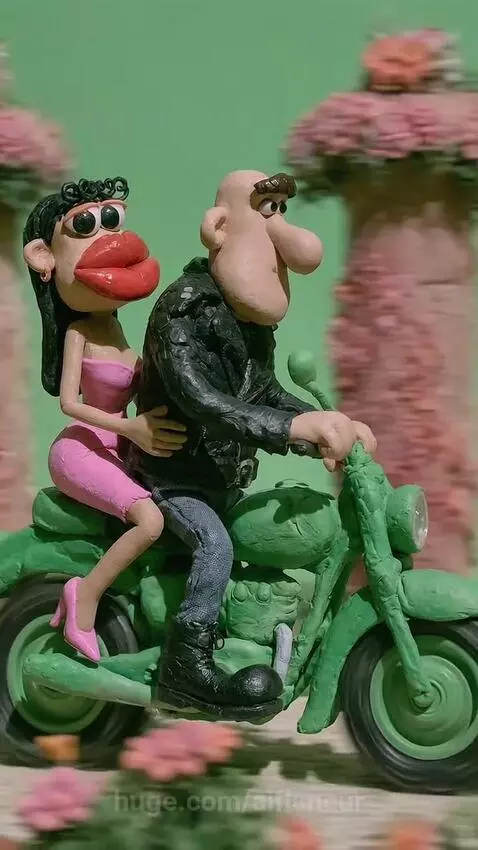 Claymation couple on a motorcycle, man in leather jacket, woman in pink dress, surrounded by flowers.