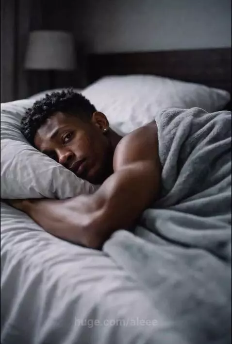 Young man in black and white gym, wearing colorful Under Armour sneakers, dribbling a basketball.