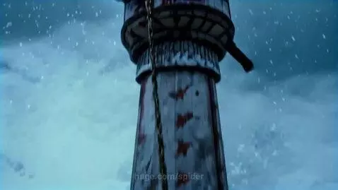 A large, black, furry cat-like creature with glowing yellow-green eyes perched on a snow-covered pillar in a foggy, snowy environment.