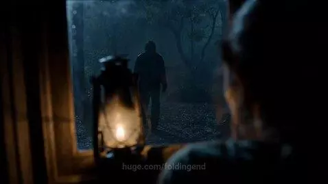 A terrified woman looks out a window at a shadowy figure with a large knife approaching in the rain.