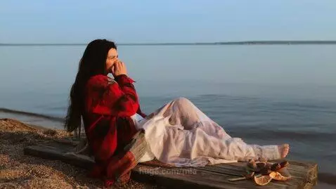 A worried beautiful lady sitting by the seashore alone by mia