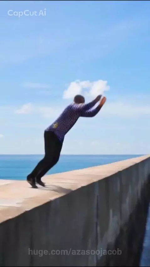 Man in blue shirt running on ocean water surface after performing a backflip.